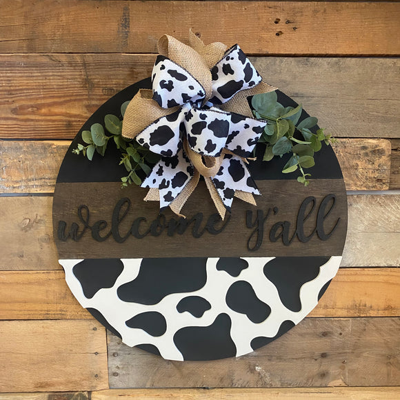 Cow Print Welcome Y’all Door Hanger, With Burlap Bow and Greenery